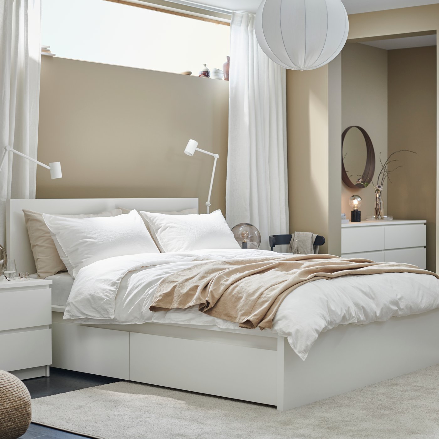 A round white REGNSKUR pendant lampshade in the bedroom