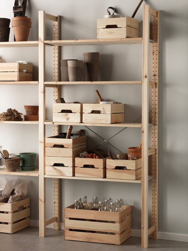A wooden IVAR shelving unit with pine KNAGGLIG boxes.