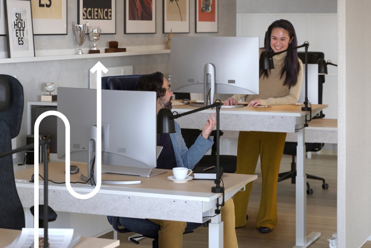 A white NYMÅNE work lamp with wireless charging