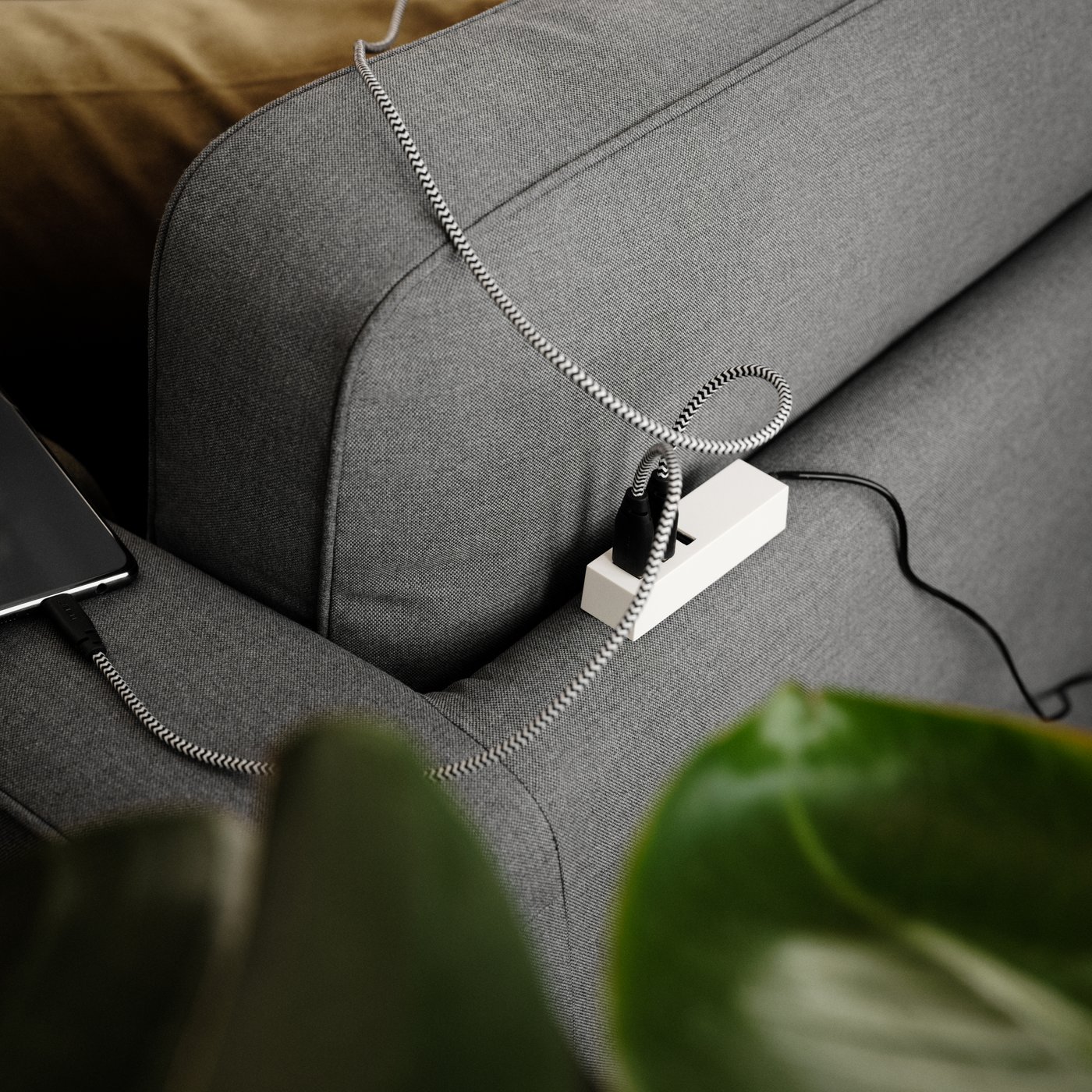 A white LÖRBY USB charger with clamp in the living room
