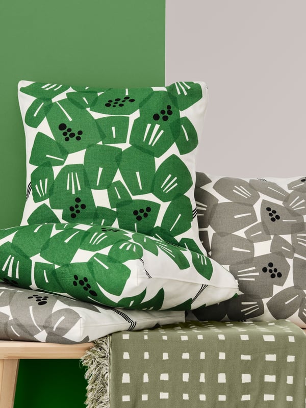 A white/green UNDERBLOMMA cushion cover