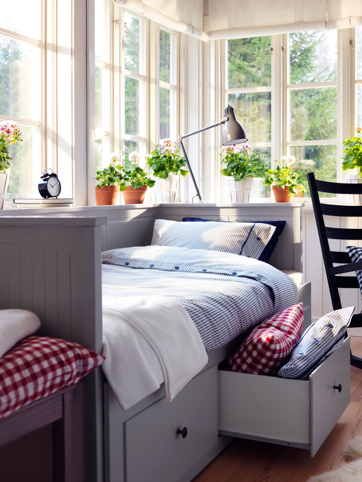 A grey HEMNES day-bed frame with 3 drawers in the bedroom