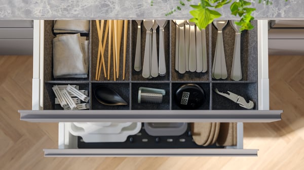 A grey UPPDATERA adjustable organiser for drawer