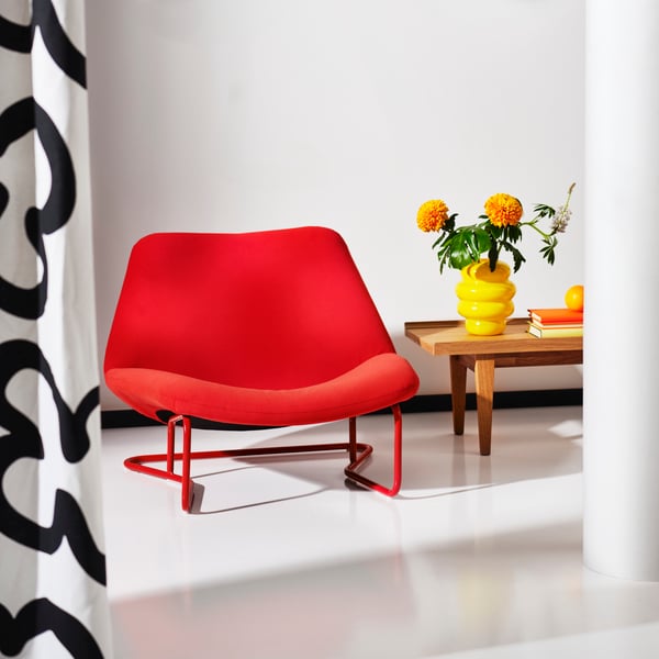 A Hakebo red SOTENÄS armchair in the living room