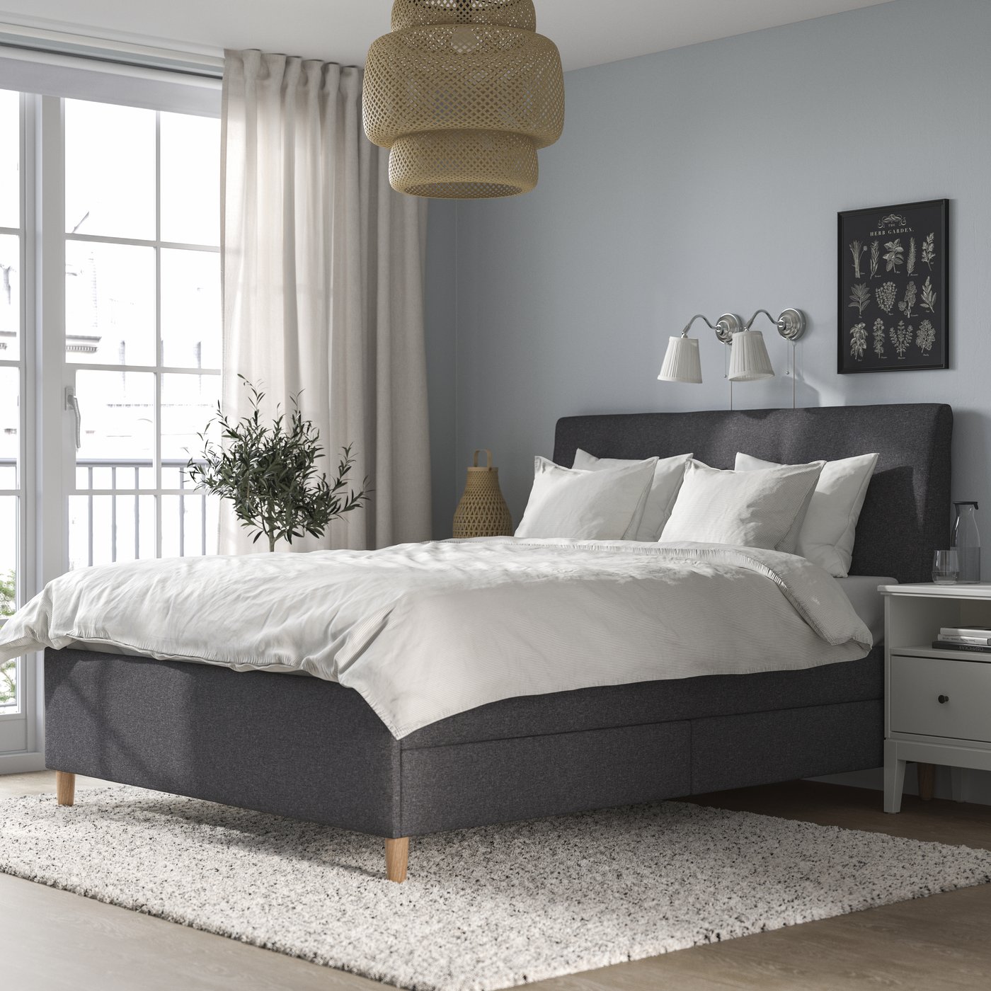 A Gunnared dark grey IDANÄS upholstered storage bed