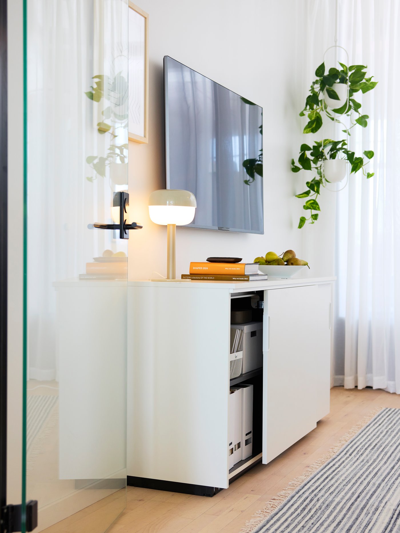 A white GALANT cabinet with sliding doors in the home office