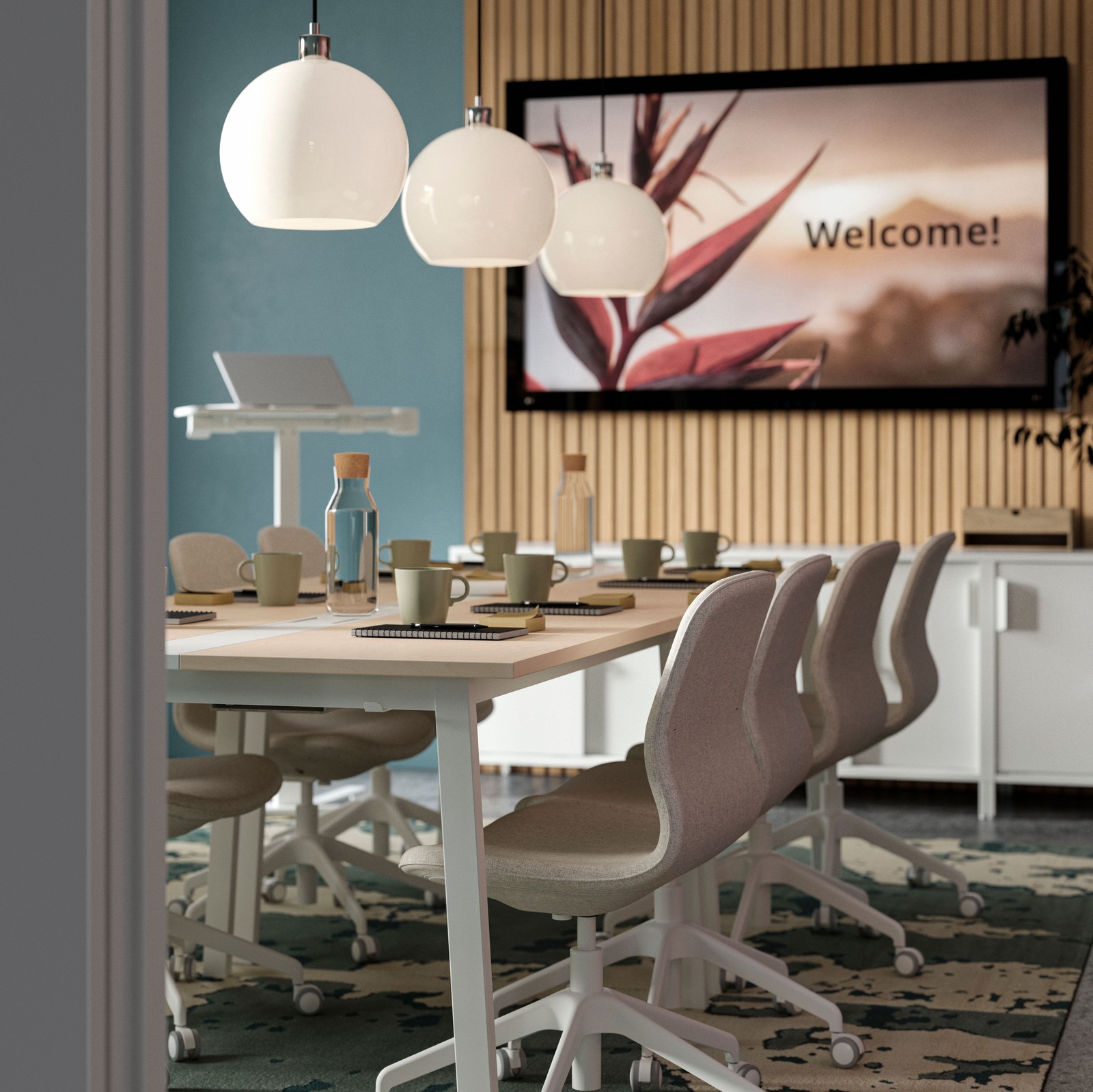 Beige/white LÅNGFJÄLL conference chairs are pushed under the long sides of two conference tables in a modern meeting room.
