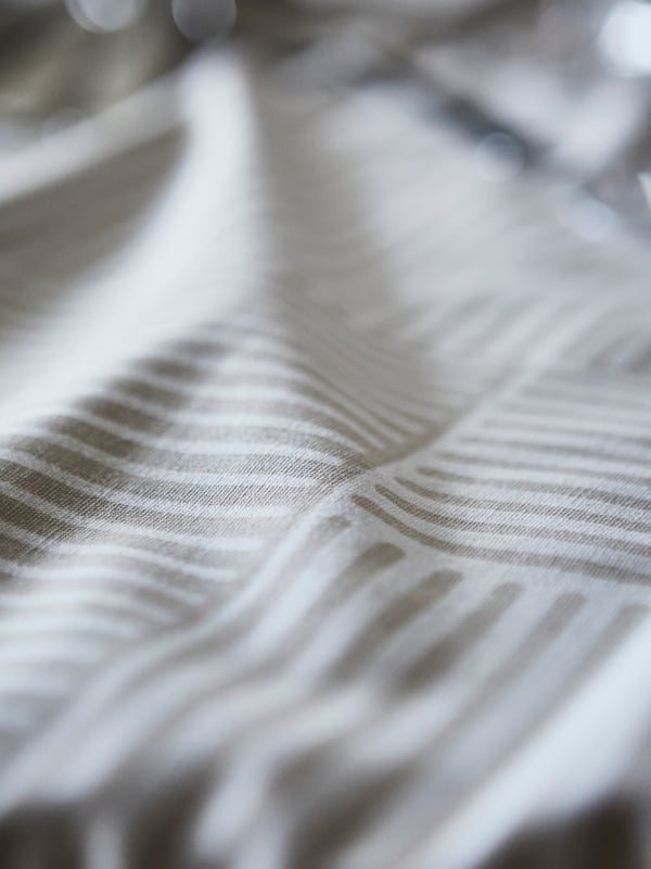 A beige HÖSTAGILLE tablecloth