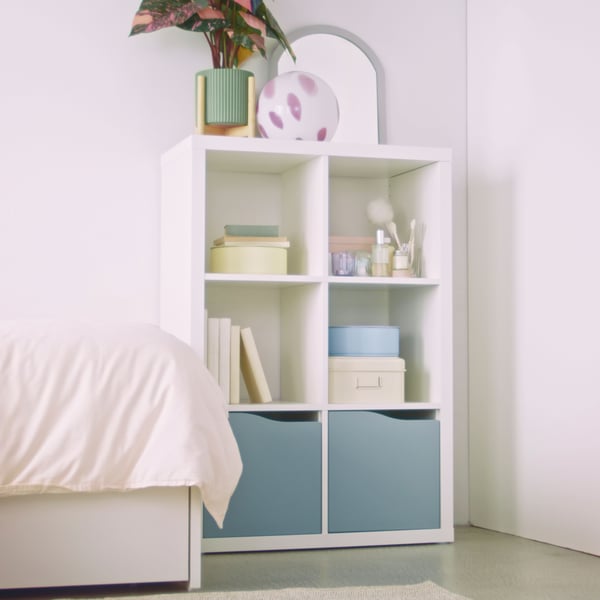 A wave shaped/light grey-blue KALLAX insert with door
