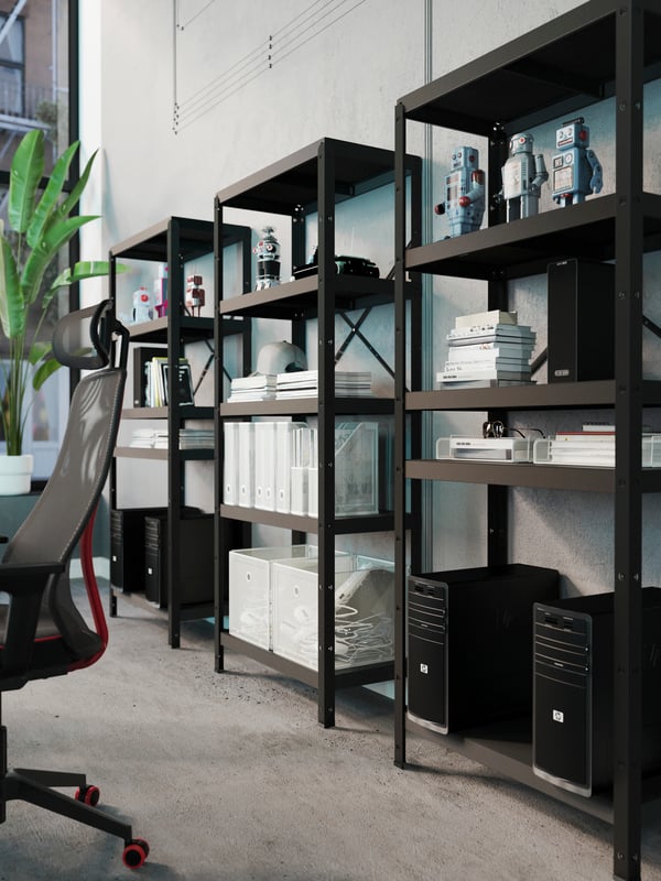 A spacious room with white DRÖNJÖNS magazine files and storage boxes tidily in black BROR shelving units along a light wall.