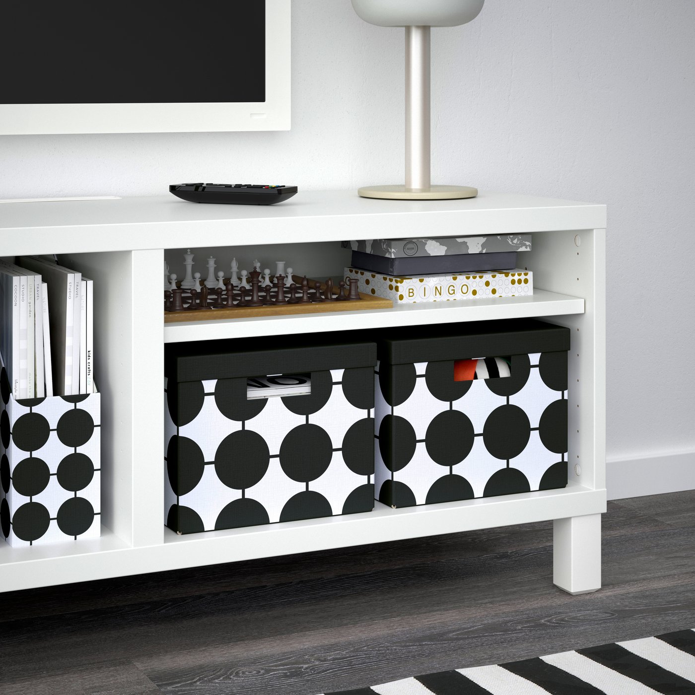 A white black/dotted TJENA storage box with lid