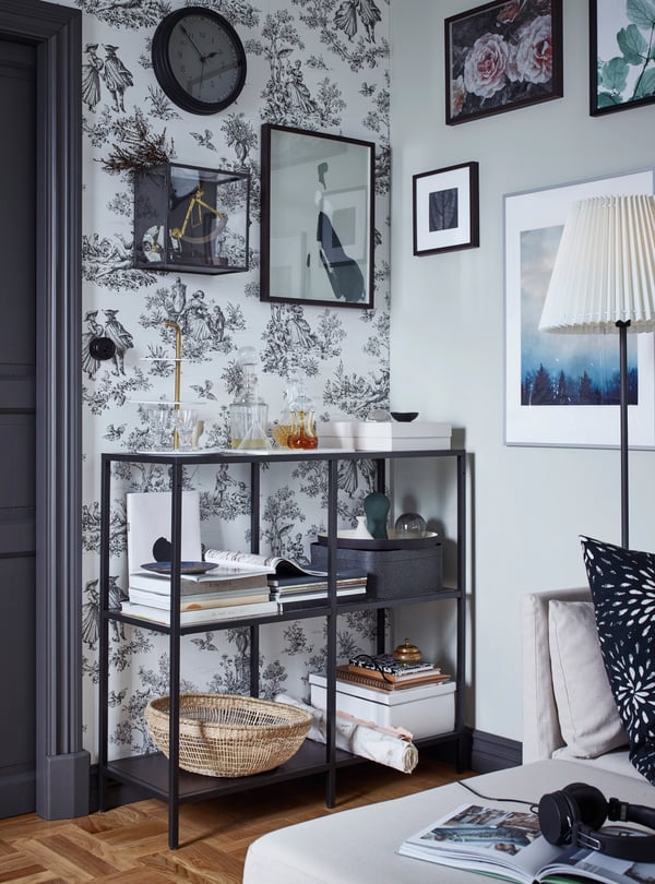 A black-brown/glass VITTSJÖ shelving unit in the living room
