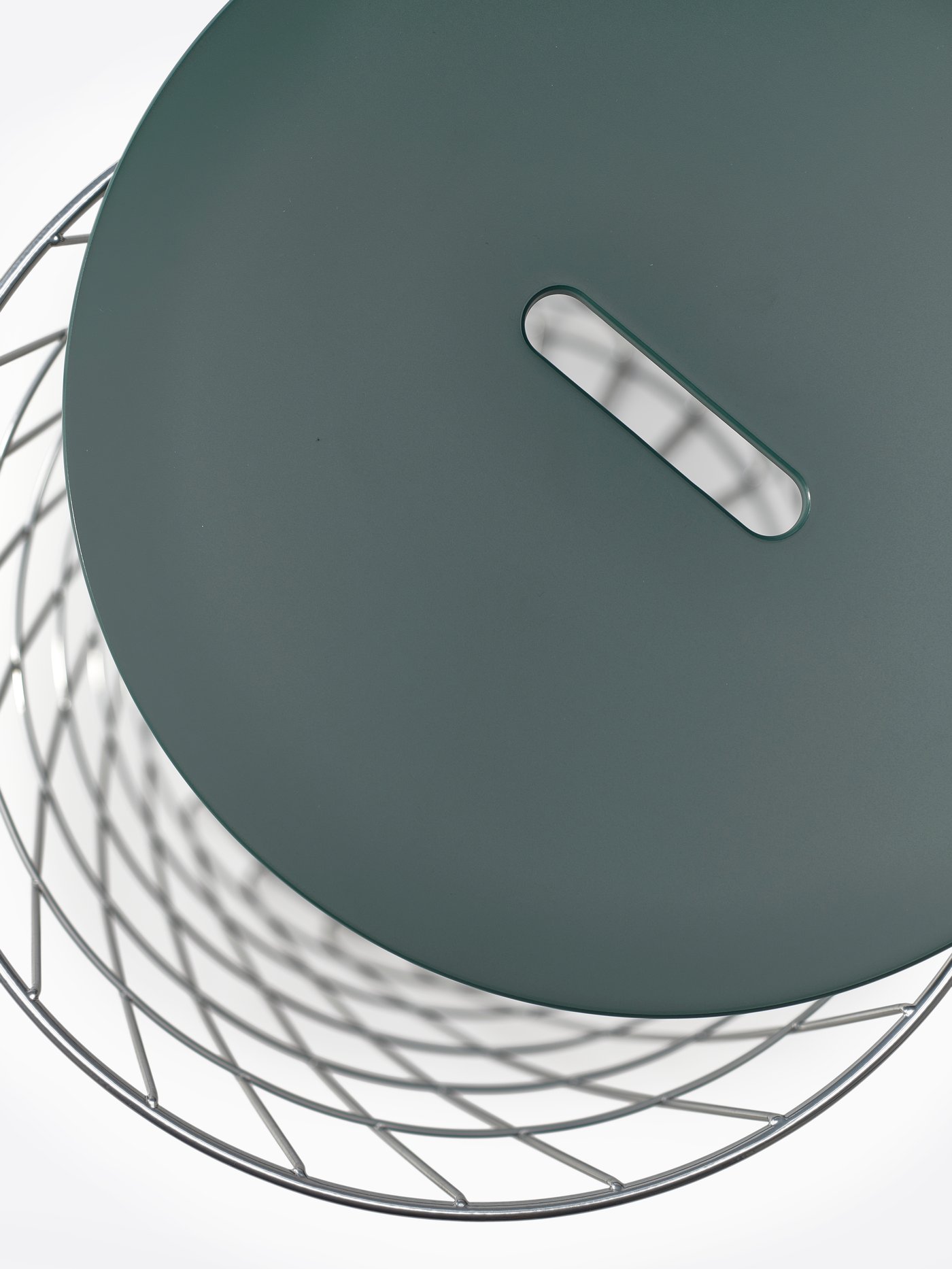 A KVISTBRO storage table pictured from above to show the lid placed slightly to the side to reveal the empty storage space.