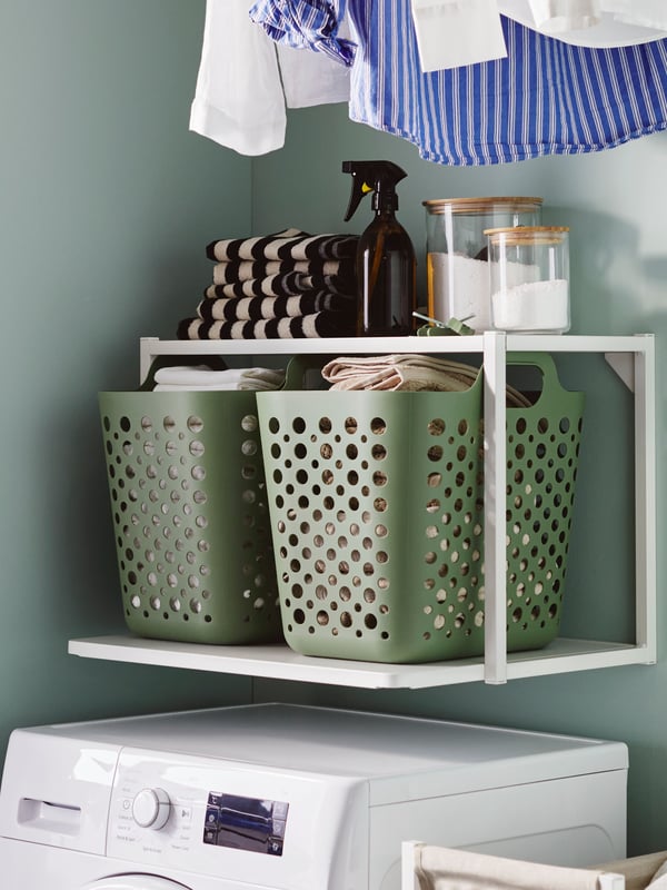 A clear glass/bamboo EKLATANT jar with lid in the laundry room
