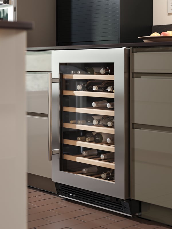 A black TITTEBO tambour storage for smaller appliances is standing on a kitchen countertop and the tambour door is open. 