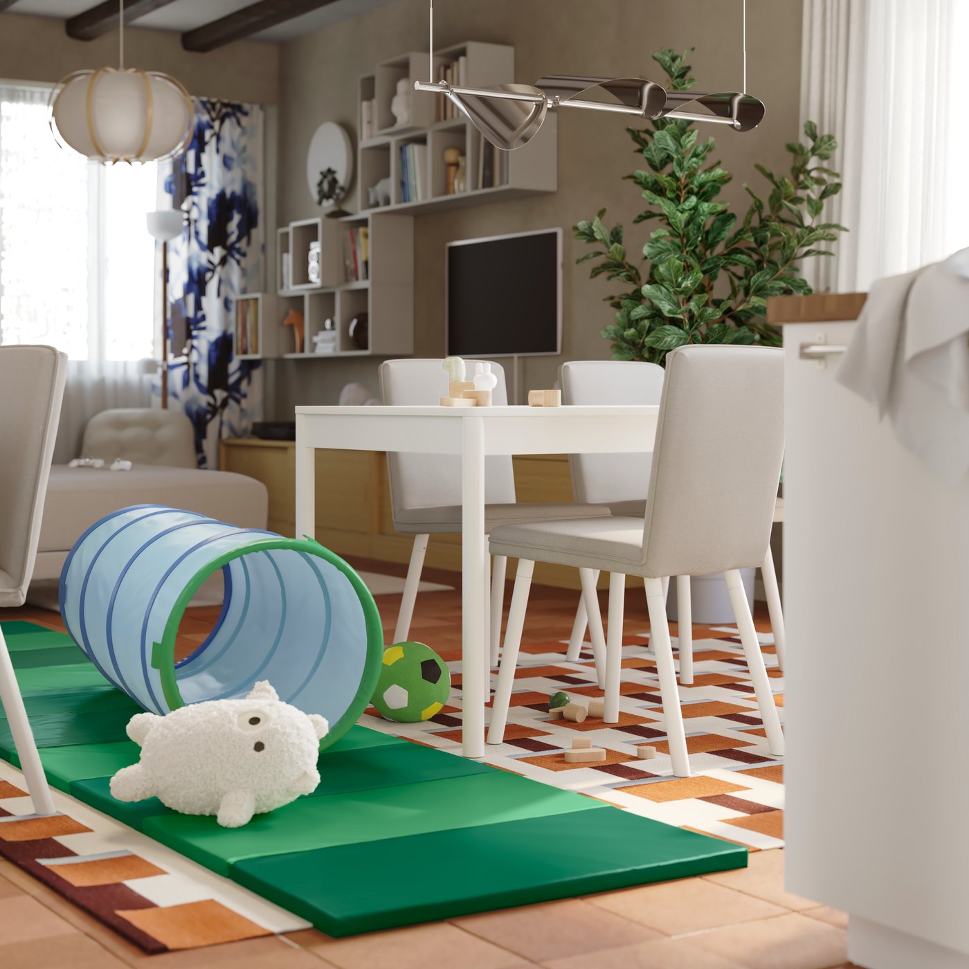 Children’s toys are lying on the floor in the middle of a home with an extendable dining table and chairs in the background.
