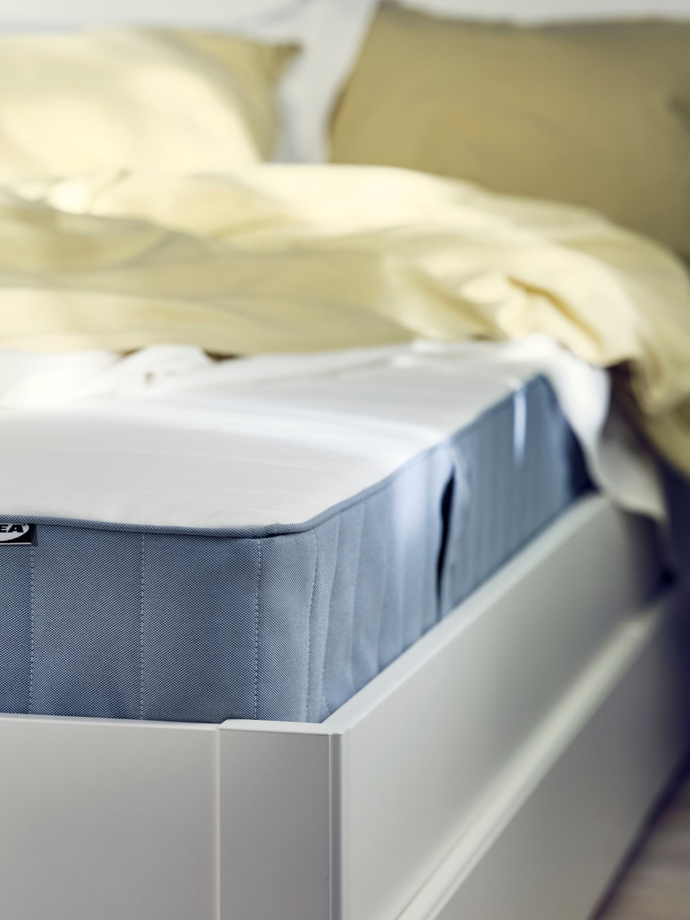 A medium firm/light blue VESTMARKA sprung mattress