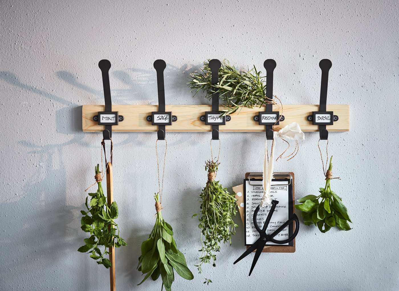 An IKEA KARTOTEK solid pine rack is a great gift for gardening friends as an herb rack. Use the five black metal hooks to hang vegetables -- or keys, coats, and other hanging accessories.
