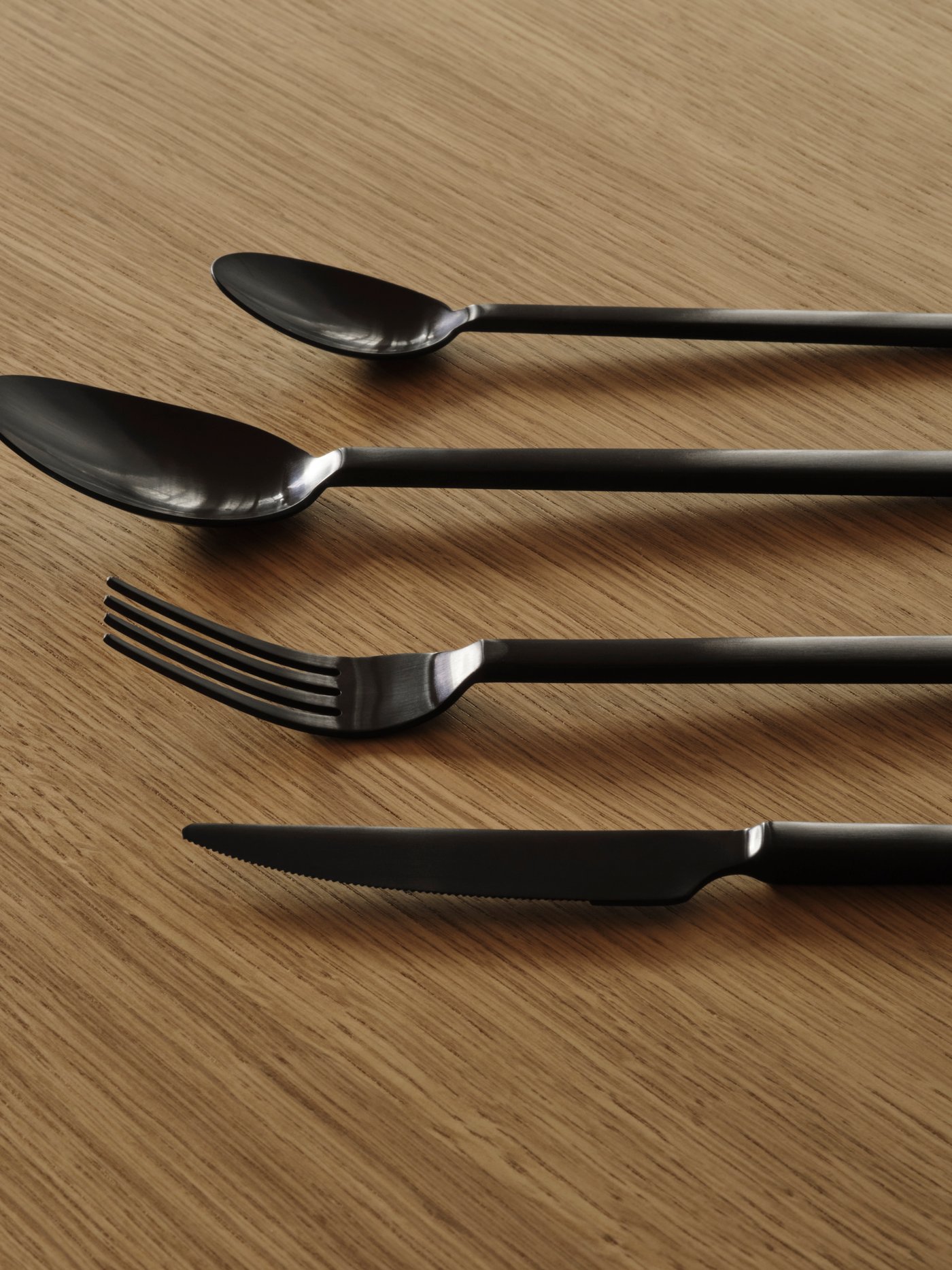 A black STOCKHOLM 2025 24-piece cutlery set