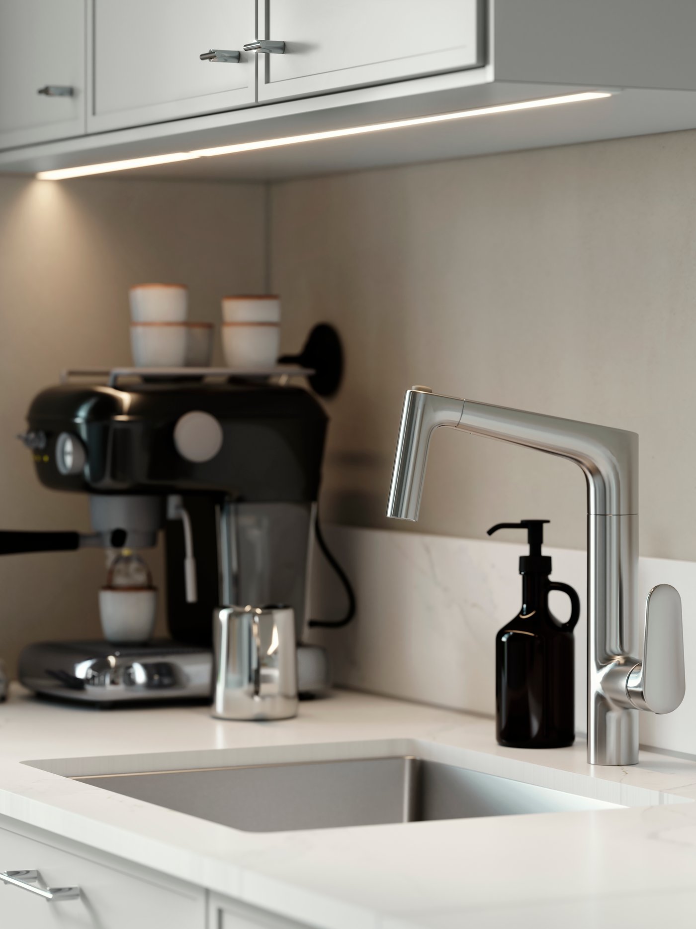 MAJSJÖN kitchen mixer tap pull out with spray, placed above a sink with white worktop and black soap dispenser.