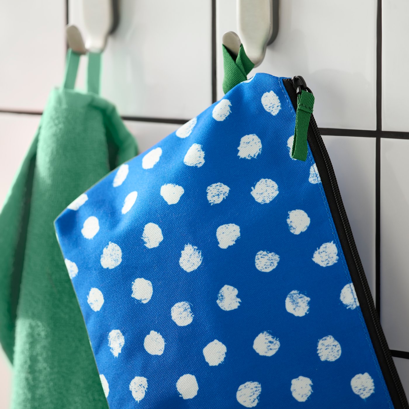 A blue/white/dotted SKOGSSALLAT toiletry bag
