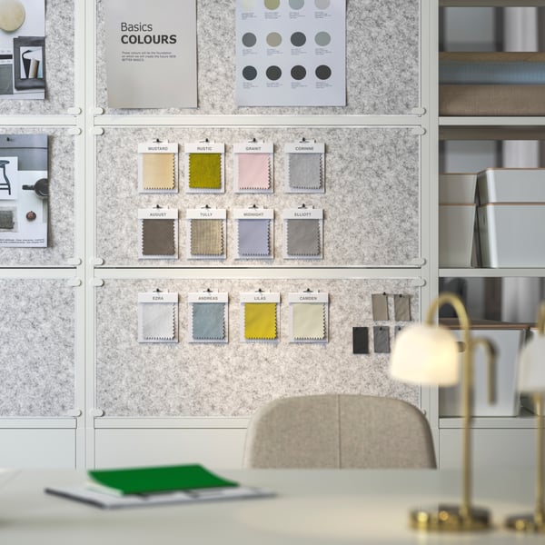Three white TROTTEN noticeboards doubling as dividers. A desk with a beige LÅNGFJÄLL conference chair sits in the front.