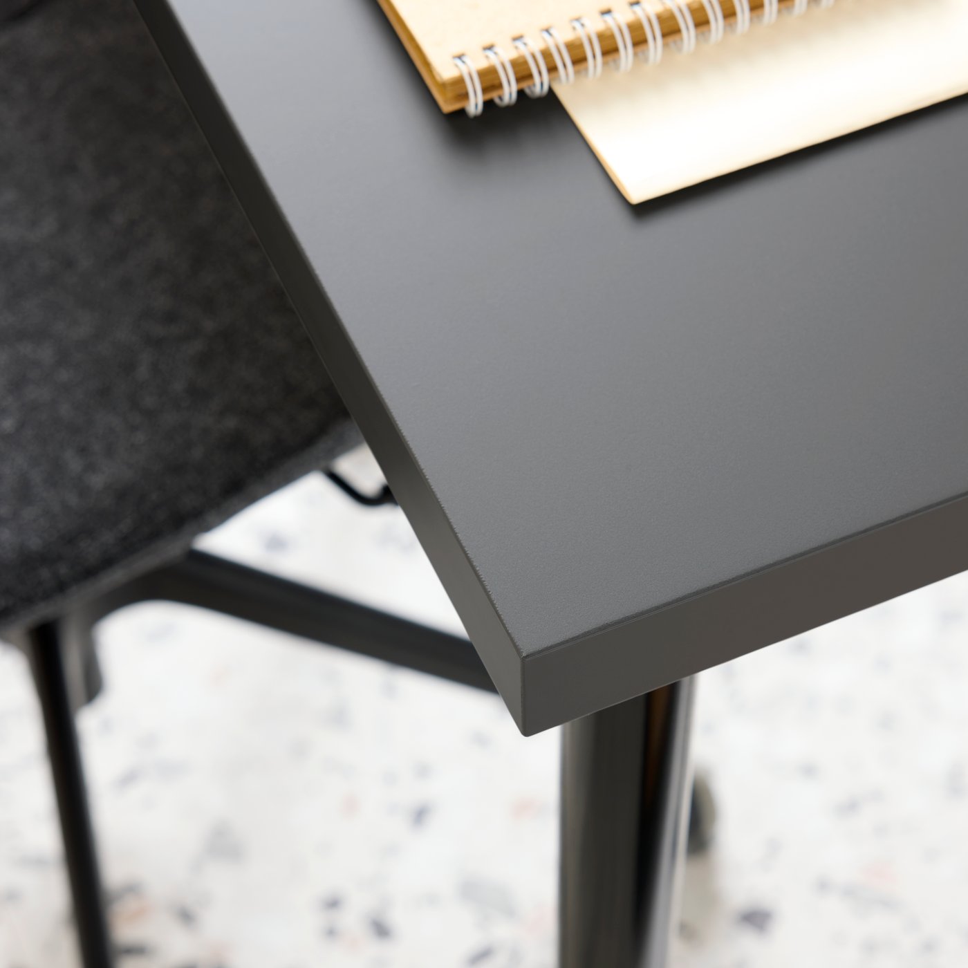 Primer plano de la mesa LINNMON y la silla de conferencias LÅNGFJÄLL en gris oscuro/negro.