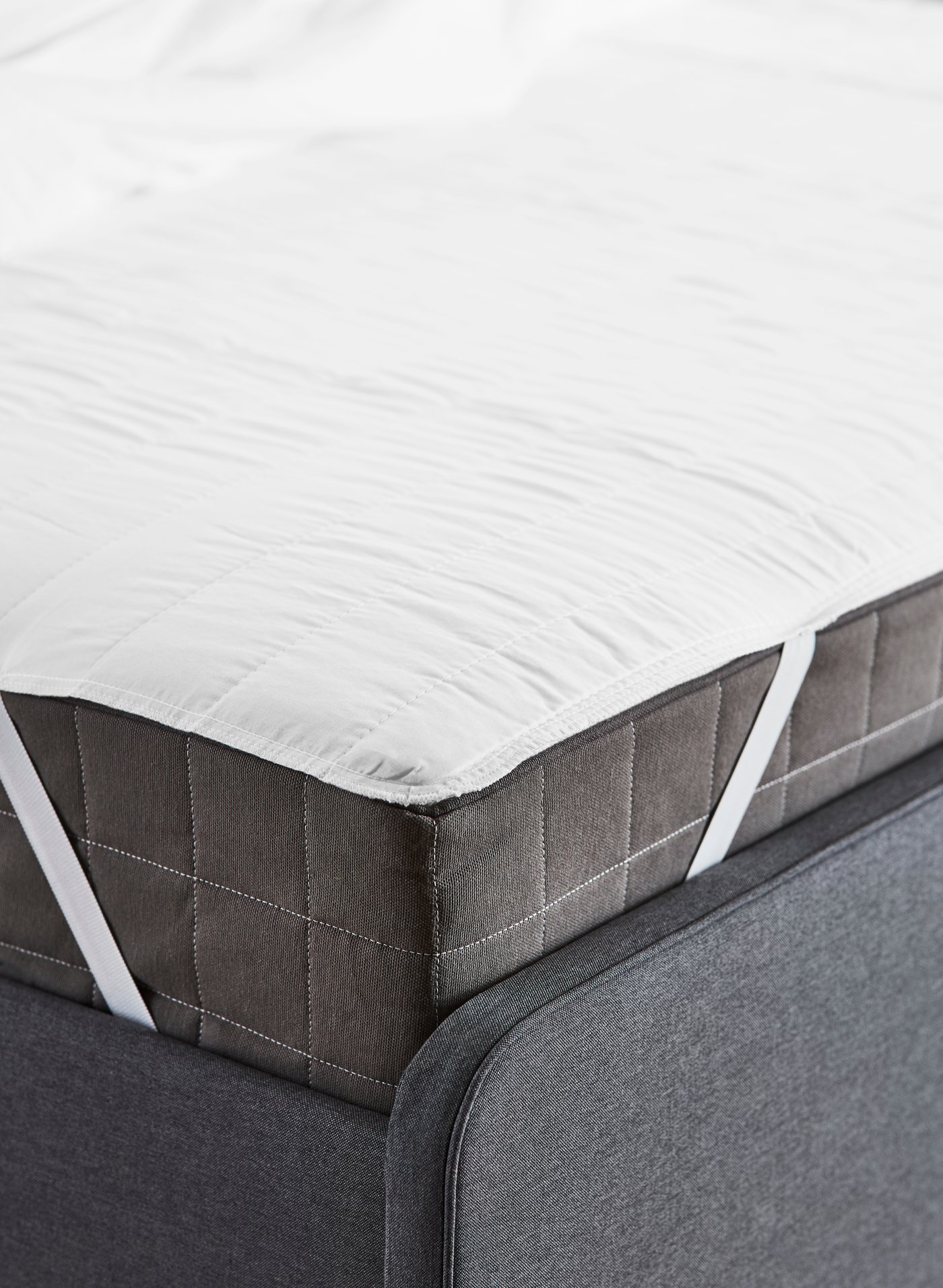 A firm/dark grey HÖVÅG pocket sprung mattress in the bedroom
