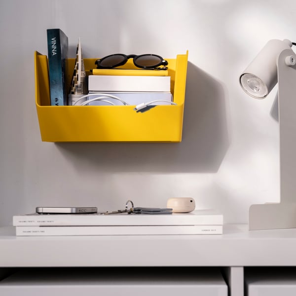 A bright yellow FODERTRÅG organiser for desk/wall