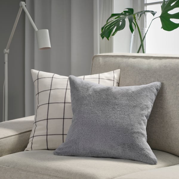 A grey ULLGRIMMIA cushion cover