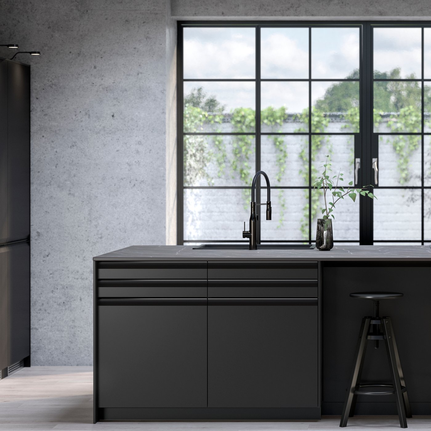 A kitchen with UPPLÖV anthracite fronts, DALFRED bar stools in black and FÖRDELAKTIG induction hob with integrated extractor.