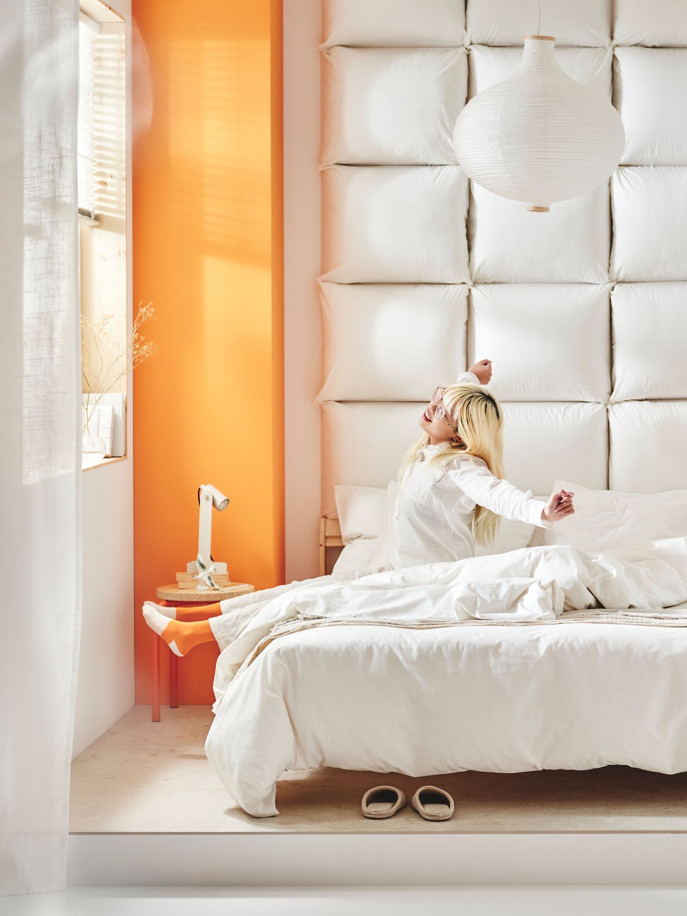 Two smiling children in pyjamases are hugging each other, one of them is holding a DJUNGELSKOG soft toy in her arms.