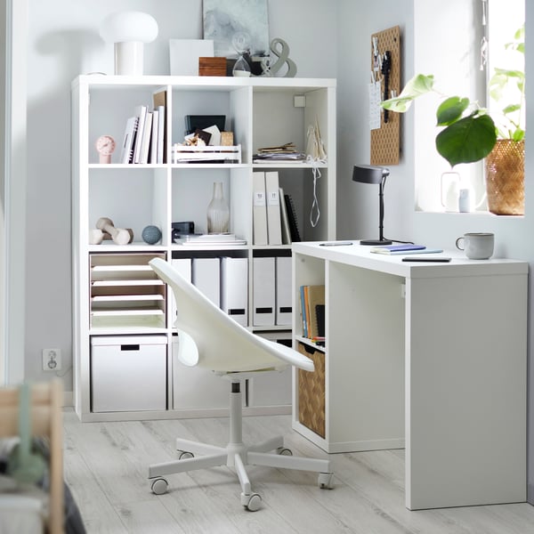 A KALLAX LOBERGET desk with white TJENA storage boxes with lids