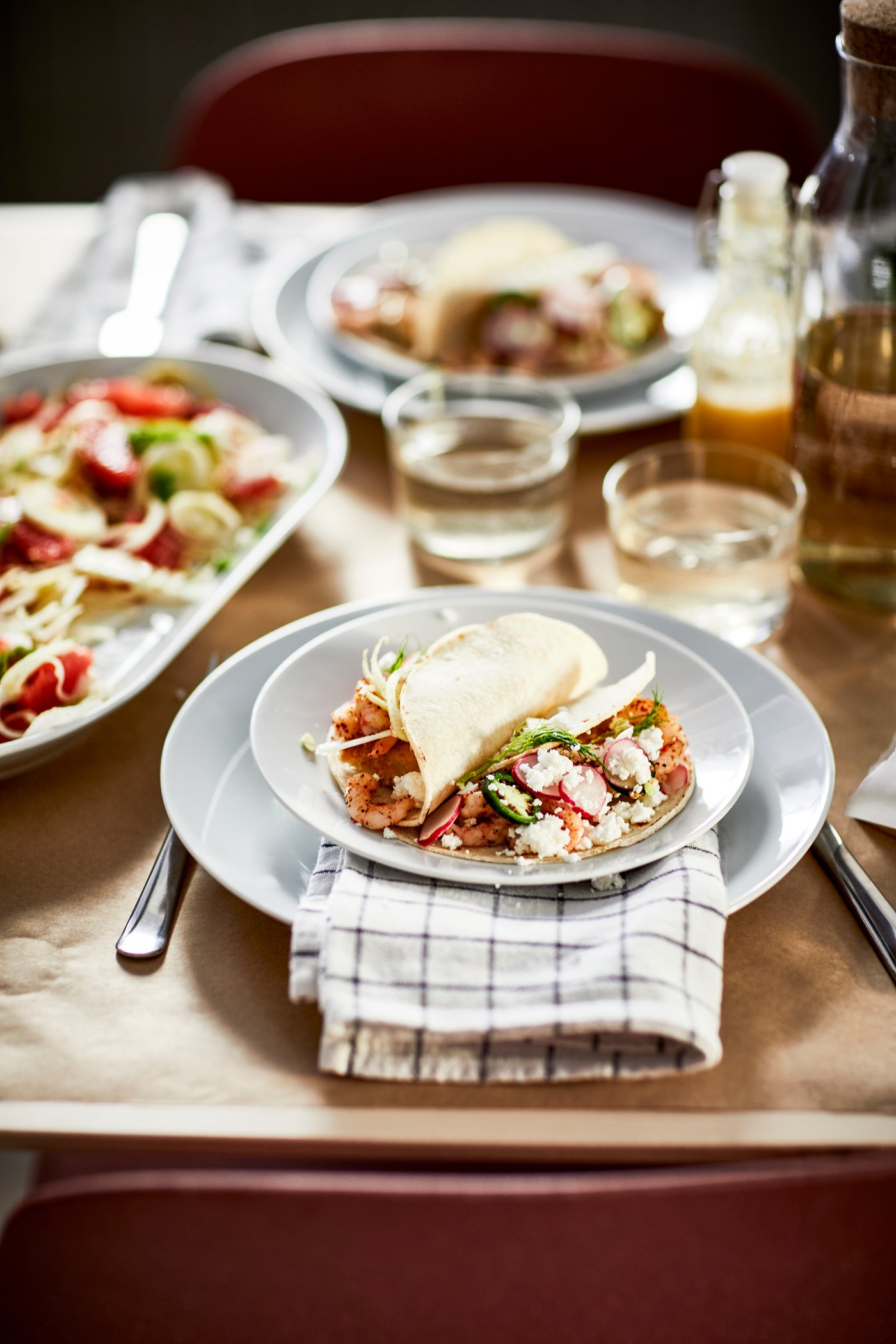 A clear glass KORKEN bottle with stopper in the dining room