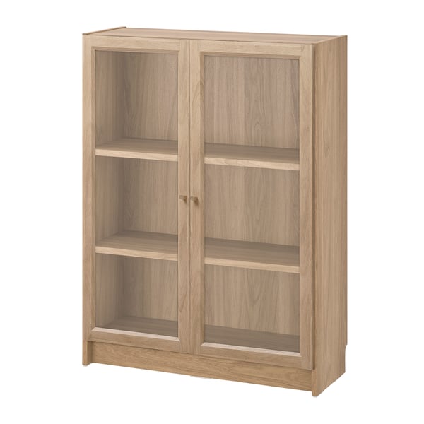 An oak effect BILLY bookcase with glass doors in the NA