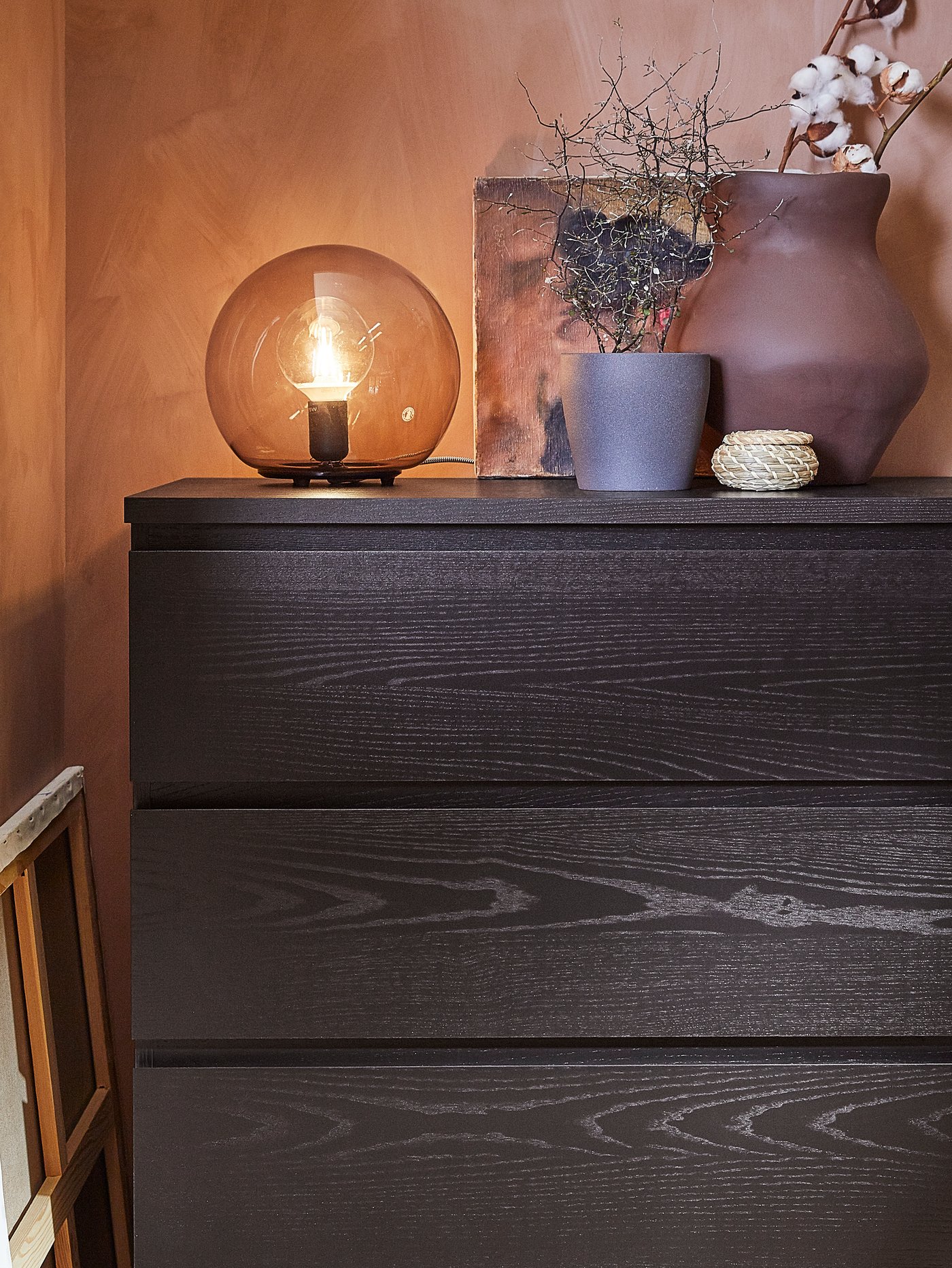 EVEDAL and FADO table lamps clustered on a cabinet, next to gold framed pictures.