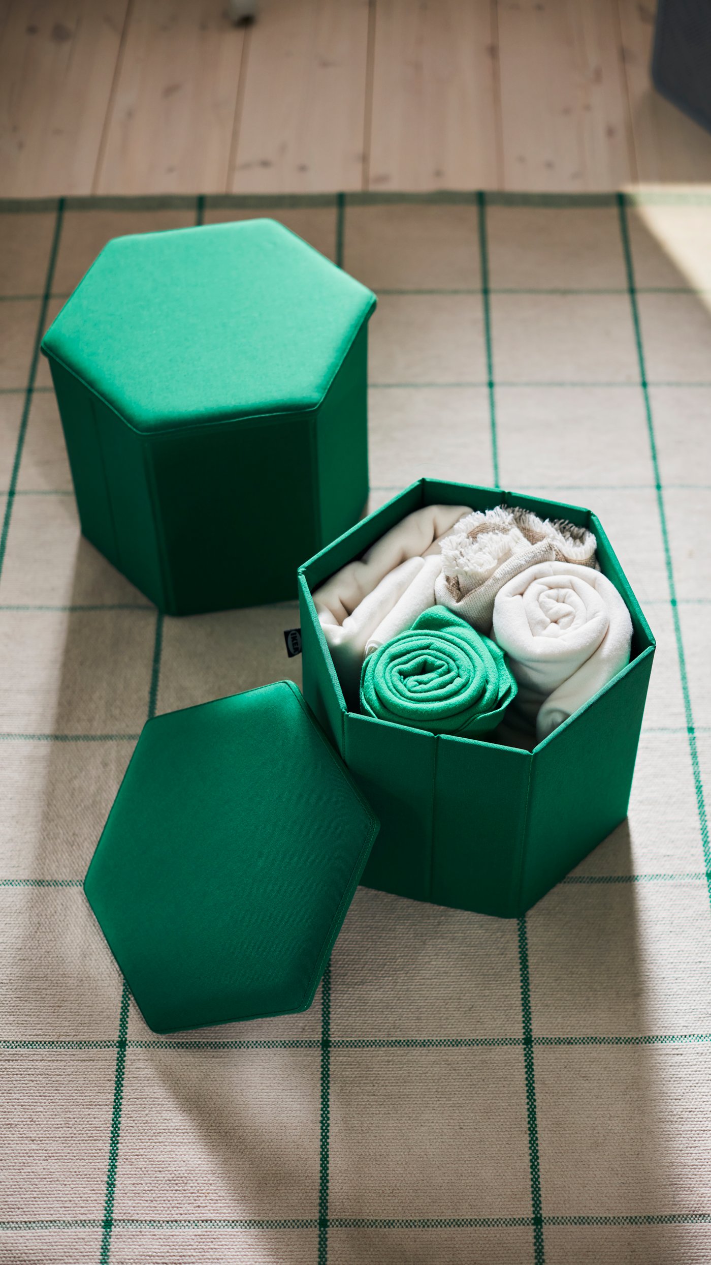 A Vissle deep green KJUGE pouffe with storage in the NA