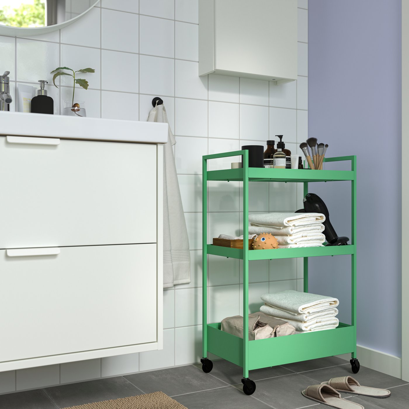 A light green NISSAFORS trolley in the bathroom