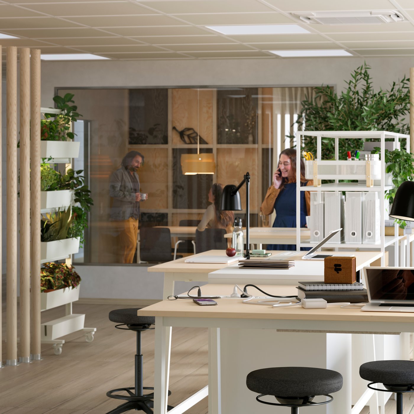 A large and modern open-plan office with MITTZON sit/stand desks placed in the middle of the space.
