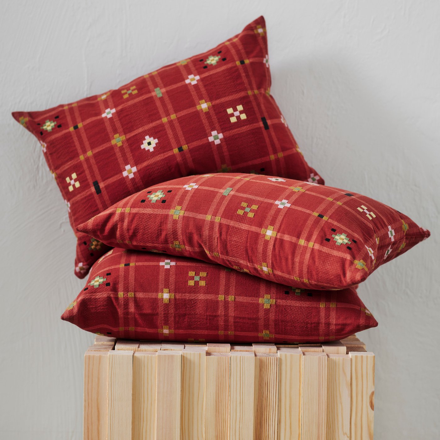 A red KUSTGRAN cushion cover