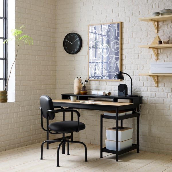 A black MULLSJÖ desk with an oak top and separate unit, paired with a dark grey MULLSJÖ swivel chair.