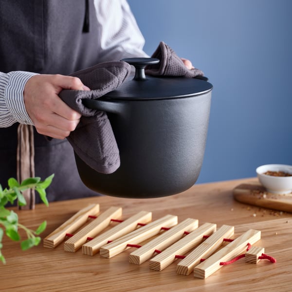 An extendable bright red/pine HALVNÄBB pot stand