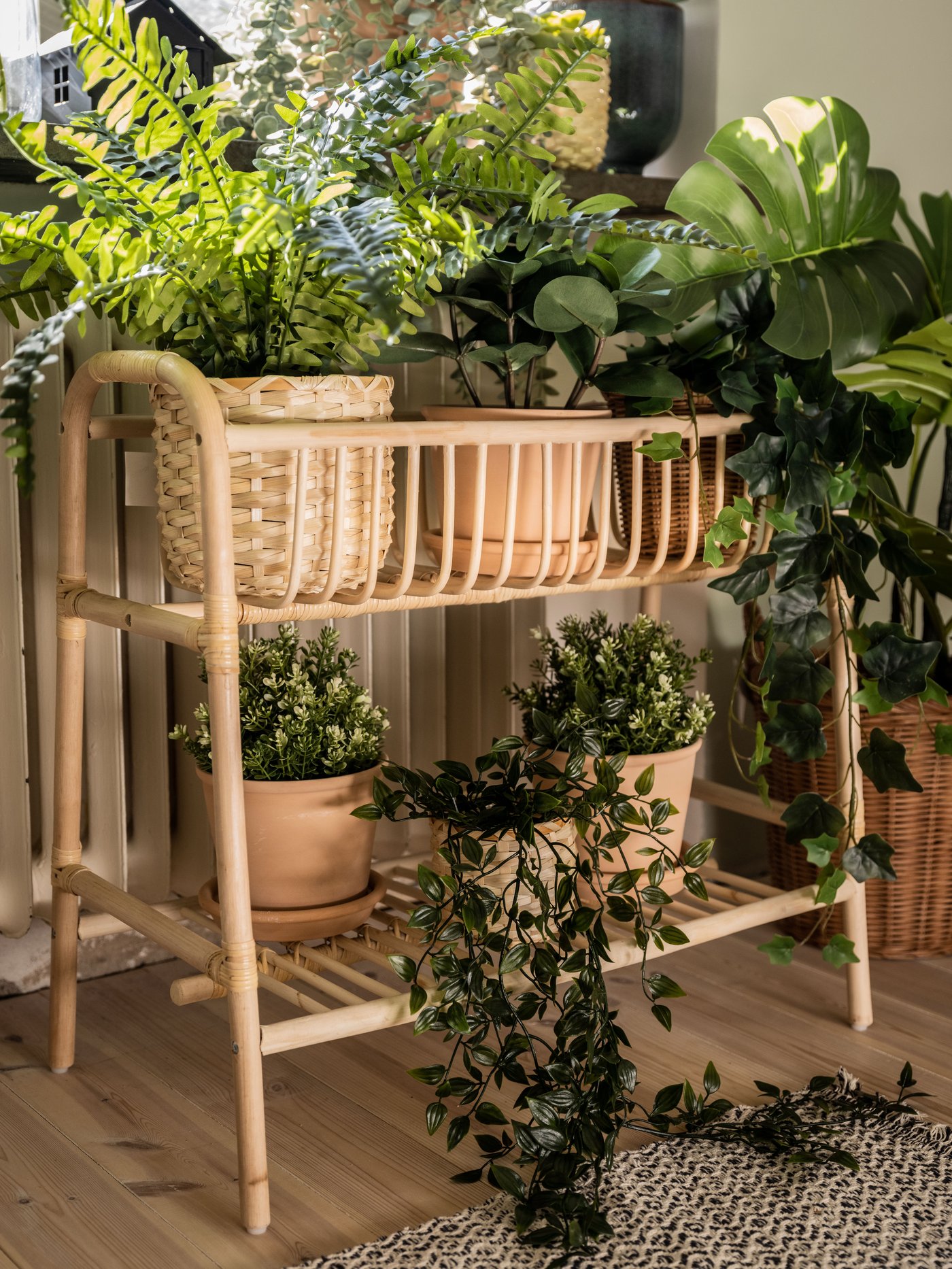 A rattan BUSKBO plant stand