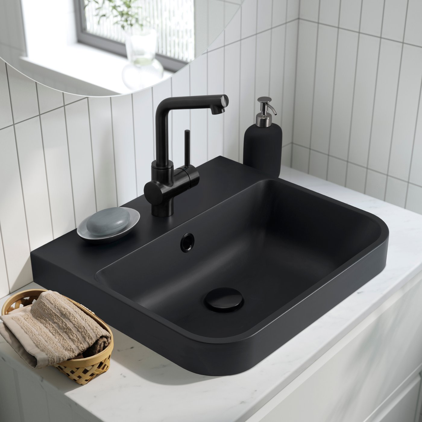 A black BACKSJÖN semi-recessed wash-basin w watr trp in the bathroom