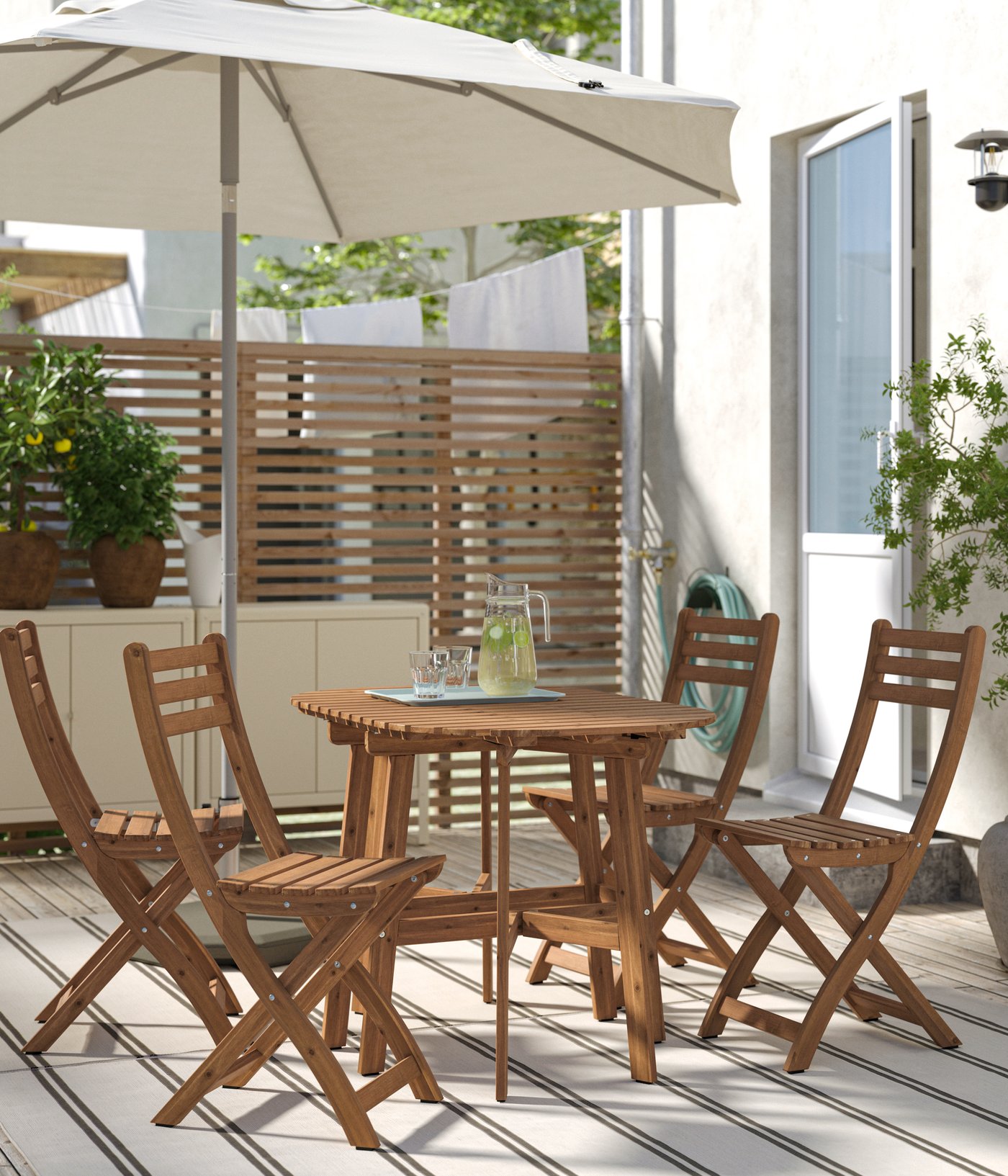 A foldable dark brown ASKHOLMEN gateleg table+4 chairs, outdoor outside
