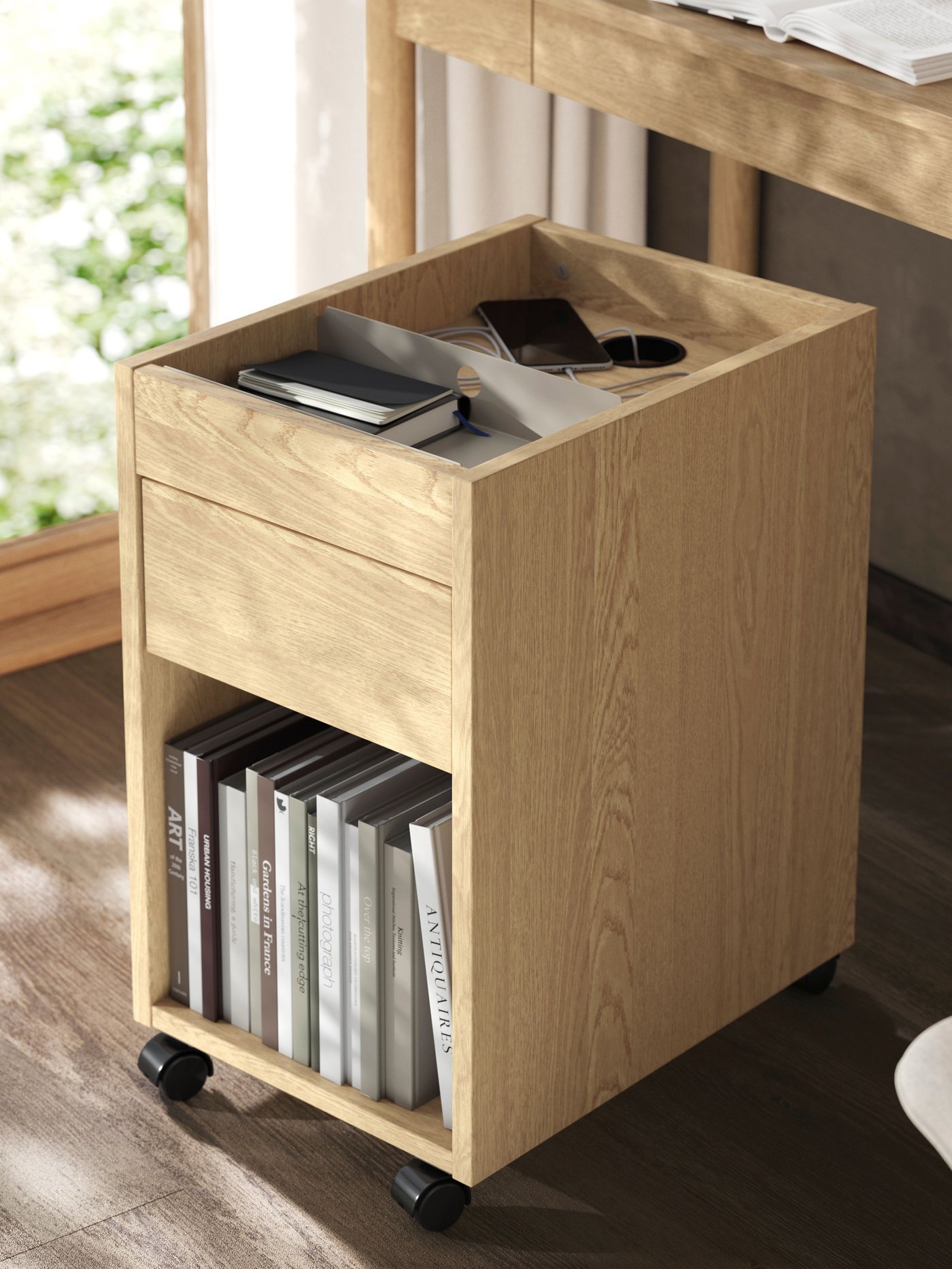 An oak veneer TONSTAD drawer unit on castors
