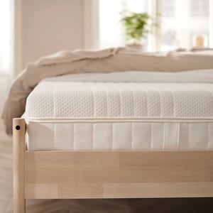 A firm/white ÅNNELAND hybrid mattress