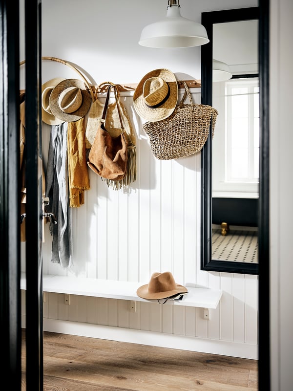 A black TOFTBYN mirror in the hallway