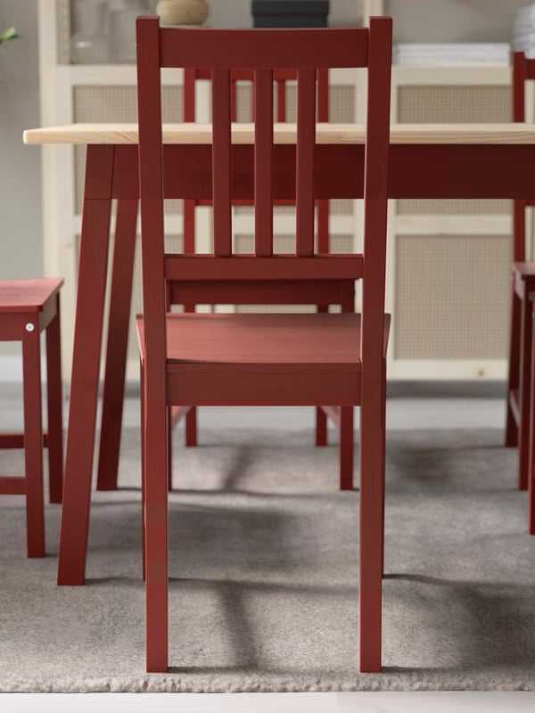 A light brown stained/red stained PINNTORP table