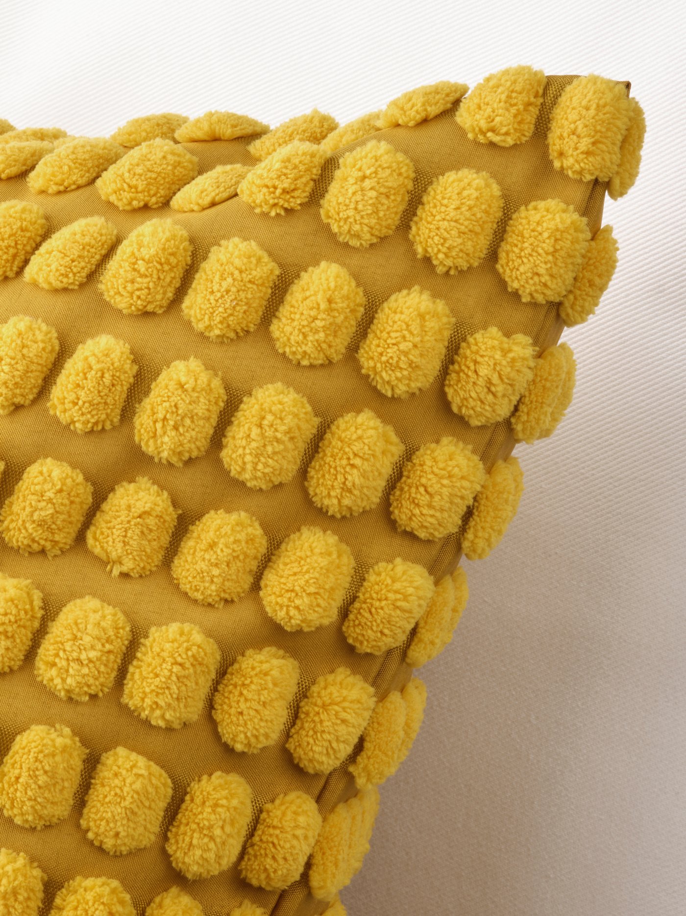 An yellow SVARTPOPPEL cushion cover